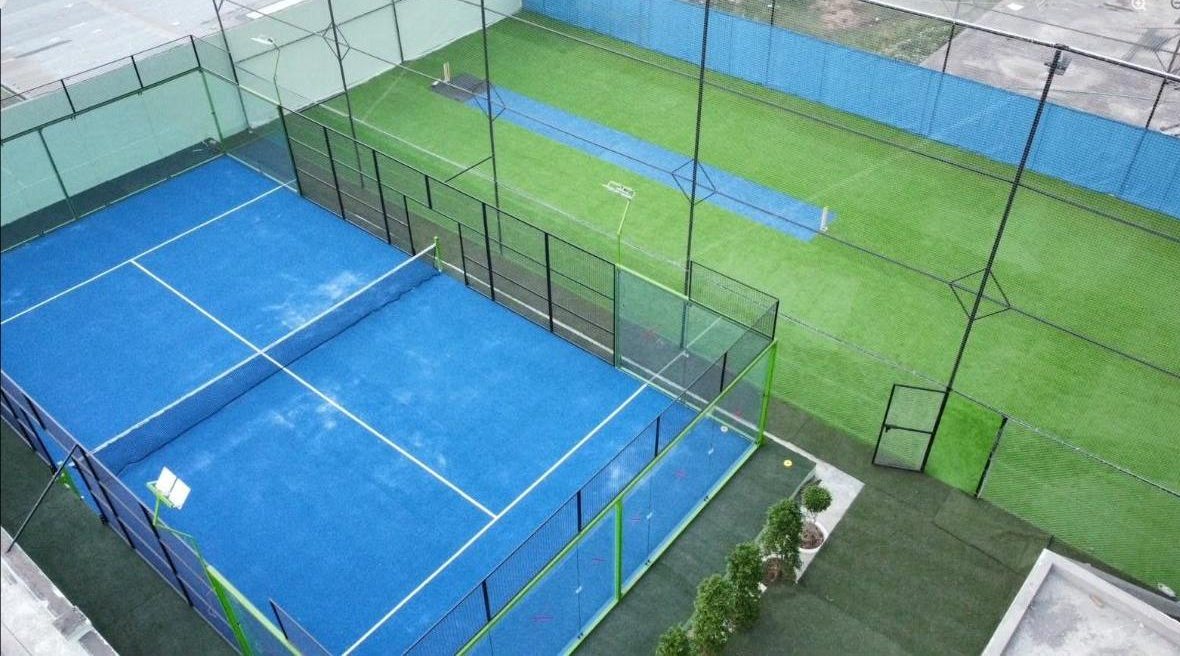 Aerial view of the padel court beside the netted cricket arena at Zone 36